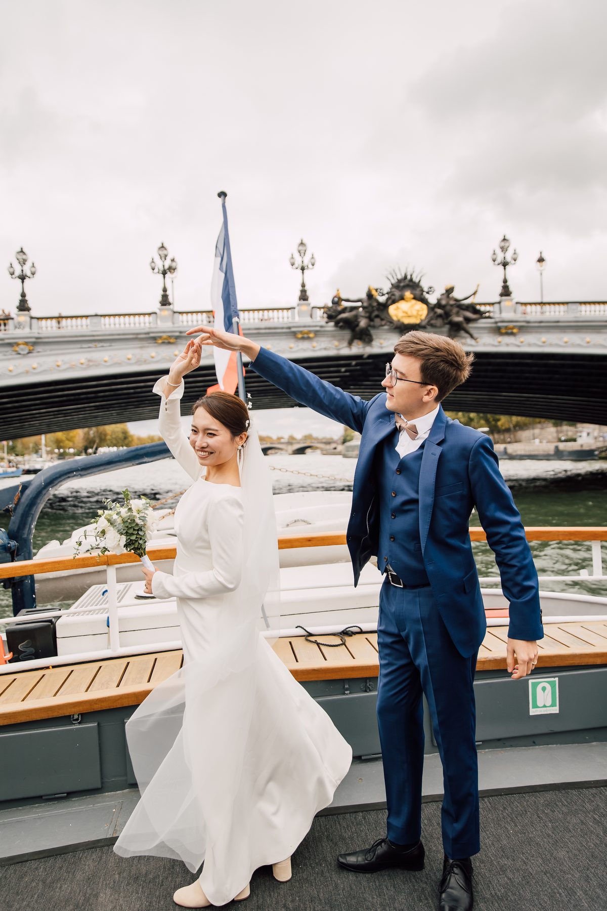 Les mariés dansent sur le pont du bateau à Paris