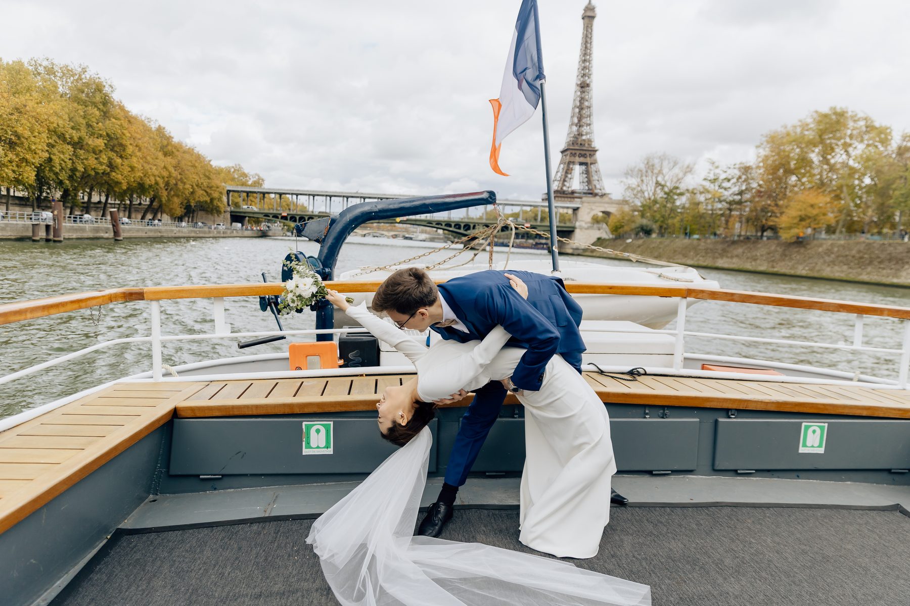 Baiser spontané des mariés sur le pont du bateau