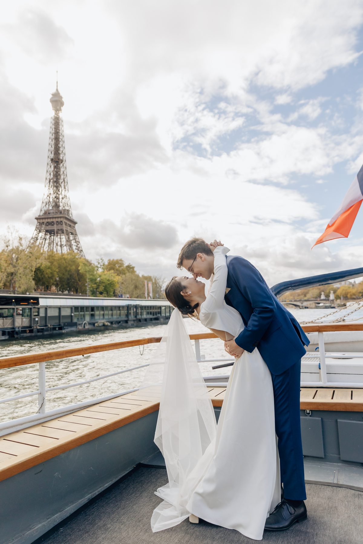Baiser des mariés pendant leur croisière parisienne