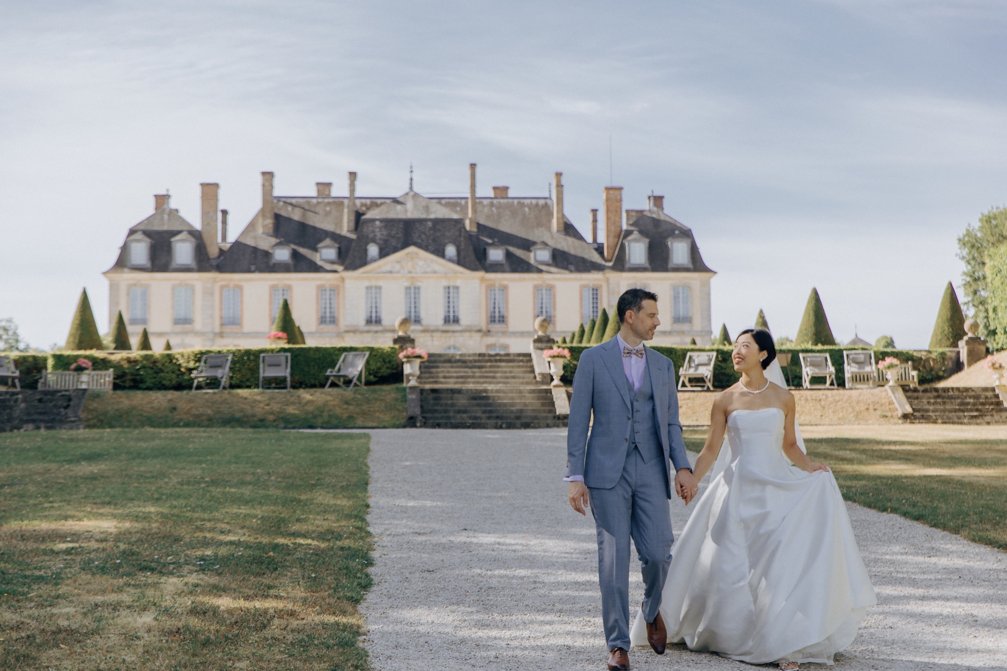 International couple walking in front of a French château