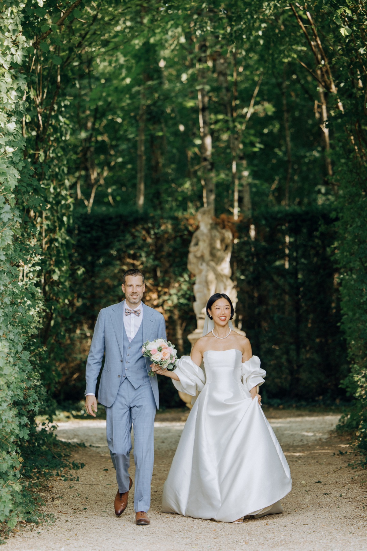 Multicultural couple photographed in a French château garden