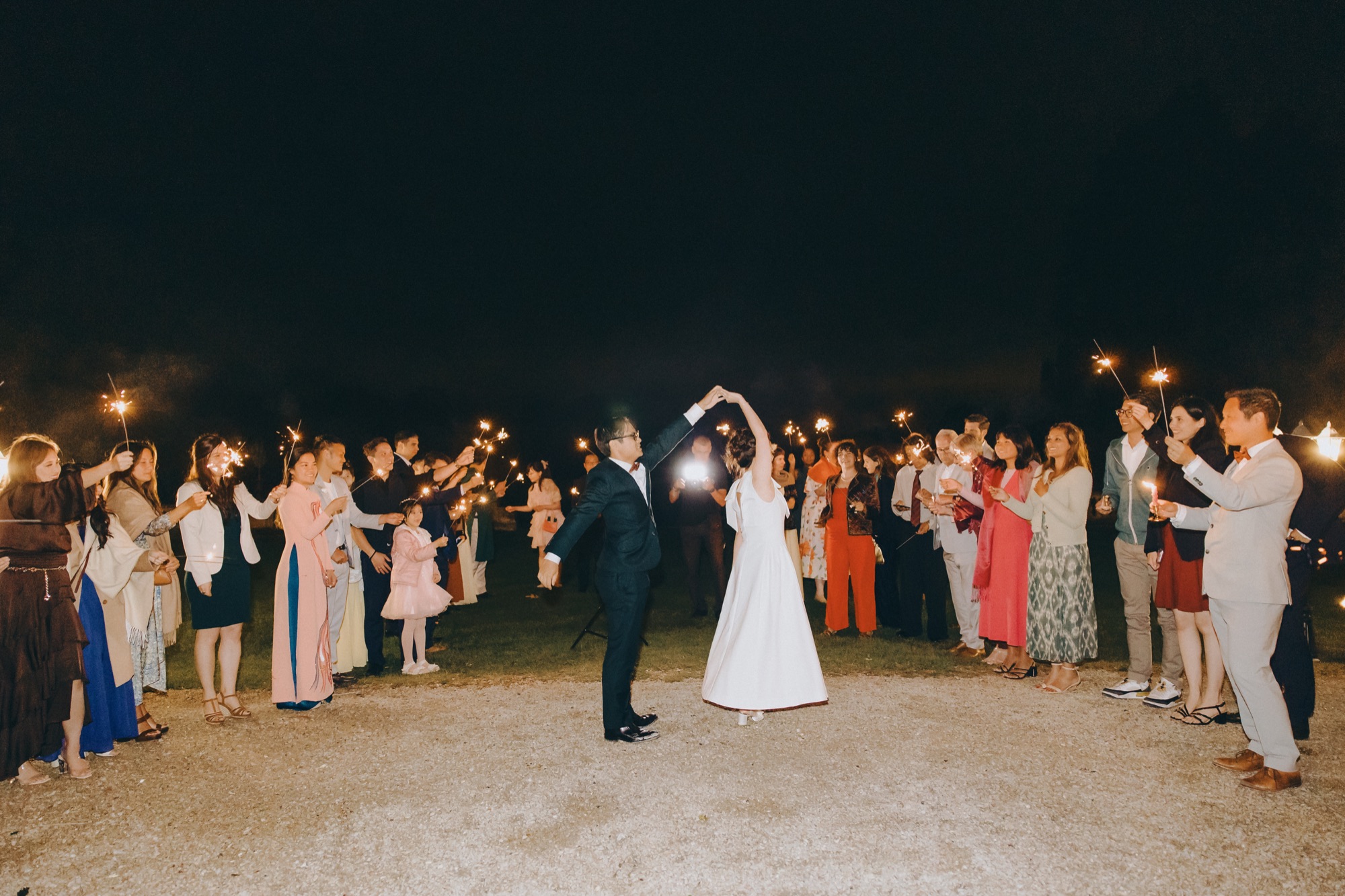 Newlyweds celebrating with guests at a destination wedding in France
