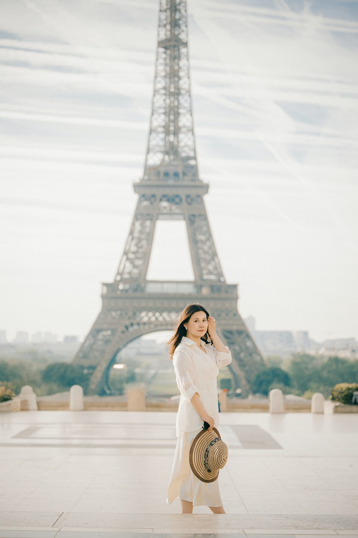 Solo traveler photographed in front of the Eiffel Tower